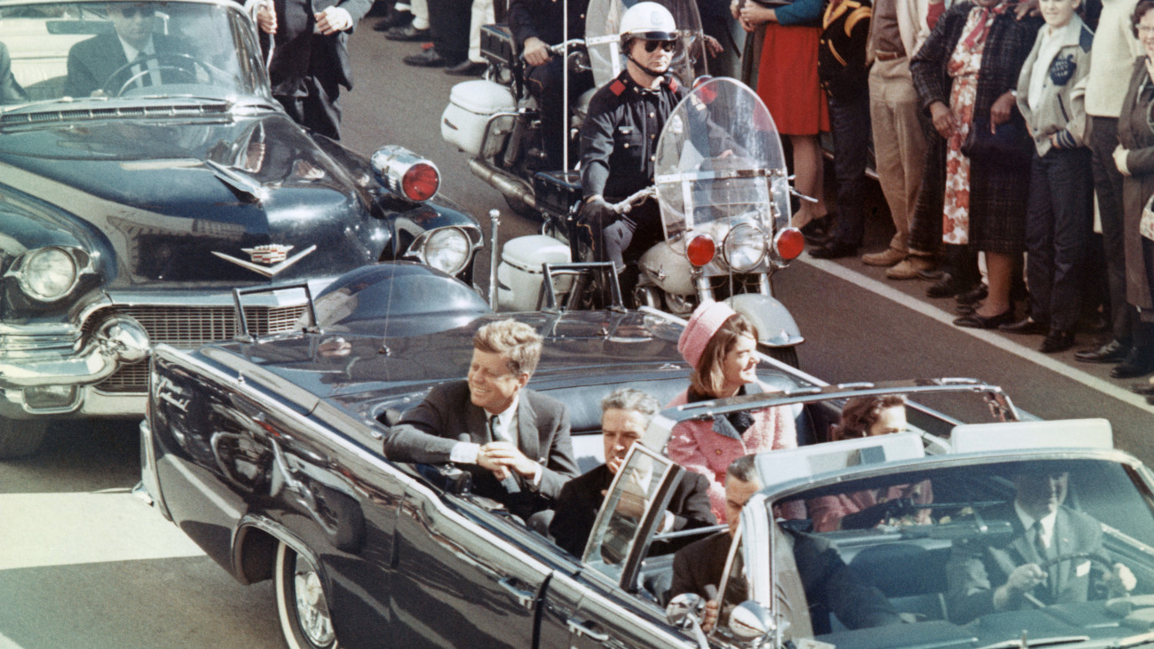 US President John F Kennedy, First Lady Jacqueline Kennedy, Texas Governor John Connally, and others smile at the crowds lining their motorcade route in Dallas, Texas, on November 22, 1963. Minutes later the President was assassinated as his car passed through Dealey Plaza.