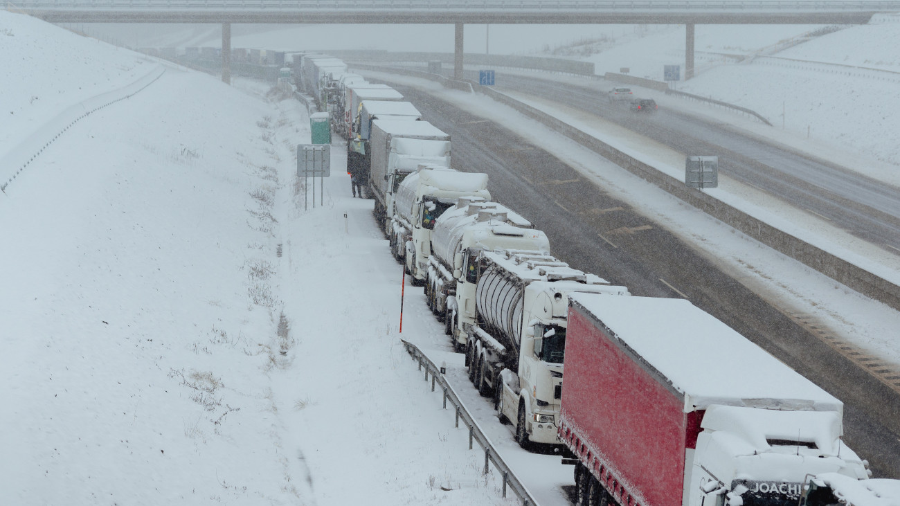 BIDOVCE, SLOVAKIA - NOVEMBER 28: Snow-covered trucks stand in a long, over 7km long queue near Bidovce, Slovakia on November 28, 2023. The recently arrived wintery conditions worsened the situation, many drivers do not have enough food or fuel, and despite the cold snowy weather, the Slovak government is not helping the waiting drivers. The Ukrainian drivers are now forced to bypass the Polish border crossings through Slovakia, after Polish truckers blocked the border crossings with Ukraine to protest against competition from Ukrainian drivers, in a dispute that complicates Kyivs war effort against Russia and its vital relations with the EU. The protest, which started on the 6th of November is blocking the border crossing between Poland and Ukraine for freight except military cargo, fresh goods and humanitarian help. Poland in September maintained unilateral restrictions on imports of Ukrainian grain to protect its domestic farmers, in violation of the EUs common trade policy. (Photo by Robert Nemeti/Anadol
