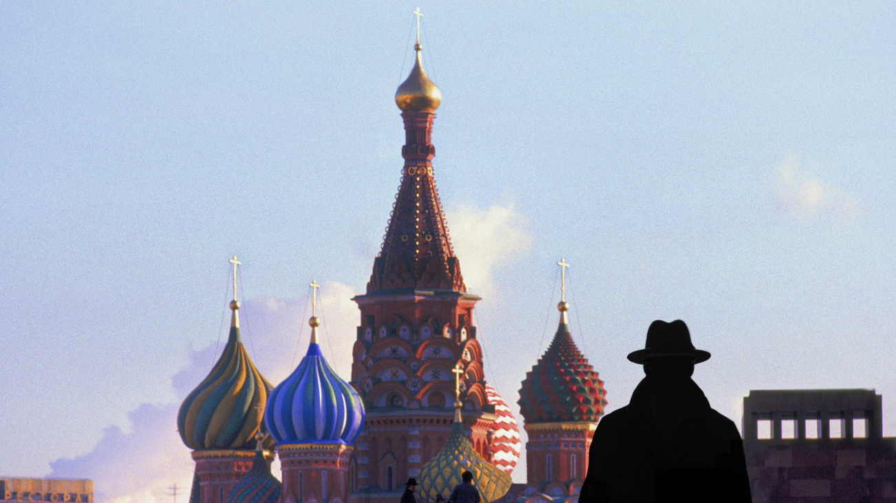 Russia Moscow Red square may 14/2014  a man in silhouette wearing a hat walking in square at twilight.