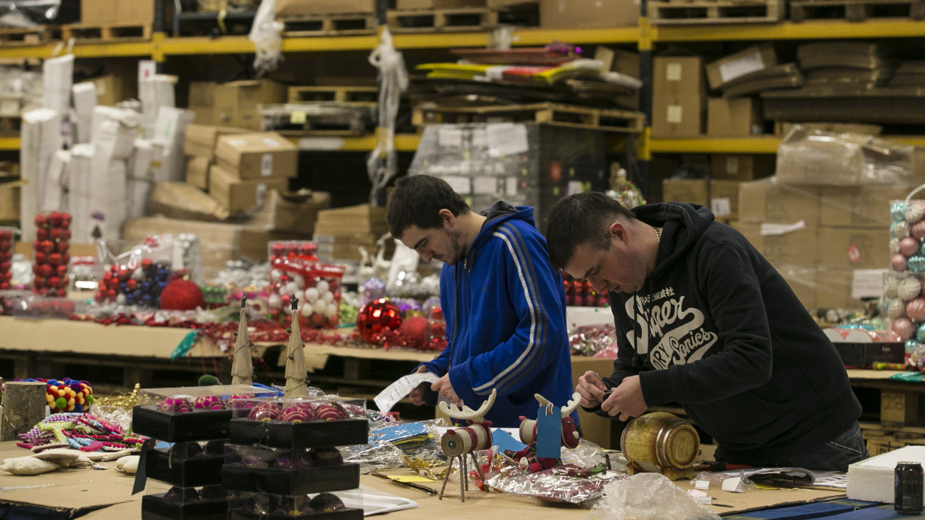 CWMBRAN, WALES - DECEMBER 10:  Festive employees (L) Nick Jones and (R) Stuart Baillieul pick out Christmas stock that will be taken to retail shows to be sold by retailers for Christmas 2014 at the Festive Productions Ltd premises on December 10, 2013 in Cwmbran, Wales. Although Christmas Day 2013 is only two weeks away, the staff at Festive are already planning and gearing up for Christmas 2014. The 14 acre fully integrated showroom, factory and warehouse measuring 250000 sq ft in size holds Festive Productions, who are now the last manufacturer of tinsel in UK - with the majority of tinsel sold in the UK made at the factory in Wales. As well as tinsel, Festive, which is one of Europes largest suppliers and manufacturer of Christmas and seasonal decorations, has increased its product portfolio, to include nearly every conceivable Christmas decoration category including baubles, tinsel garlands, wreaths, lights, fibre optic trees and artificial trees.  (Photo by Matt Cardy/Getty Images)