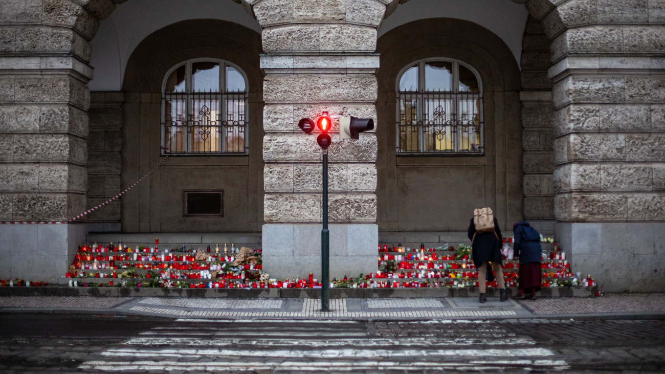 Gyászoló emberek leróják tiszteletüket a prágai Károly Egyetem főépülete előtt 2023. december 23-án. Két nappal korábban az egyetem egyik 24 éves diákja a bölcsészkar belvárosi fő épületében nyitott tüzet, és 14 embert megölt, majd rendőrségi jelentések szerint magával is végzett. Otthonában egész fegyverarzenált találtak.