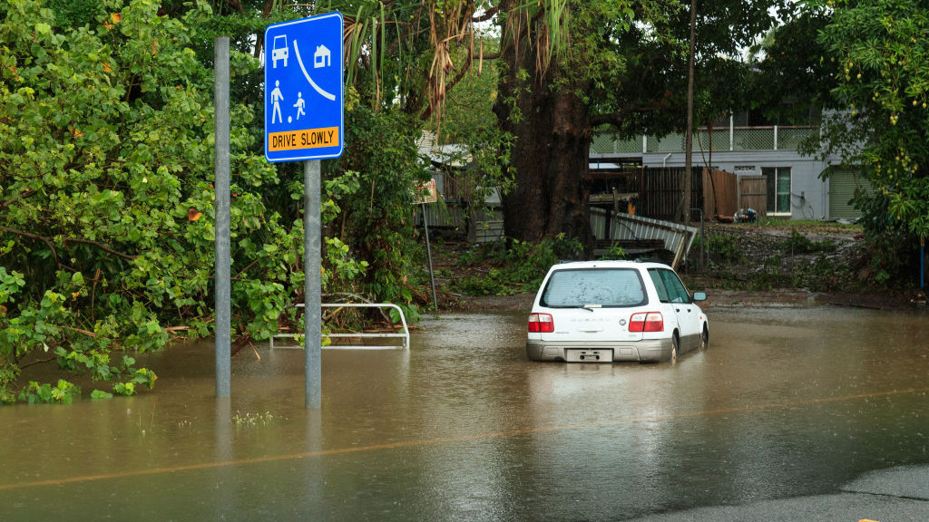 CAIRNS, QUEENSLAND, AUSTRALIA - 2023/12/15: A car inundated with water in the northern beaches suburb of Holloways Beach in Cairns after Tropical Cyclone Jasper. Tropical Cyclone Jasper made landfall over the Cairns region as a Category 2 System on Wednesday 13 December, bringing widespread flooding, debris and powerful winds. Many in Far North Queensland are familiar with tropical storms, but varying terrain and prior ground and coastal conditions continue to bring new problems such as flash flooding and erosion. Some areas such as the suburbs of the Northern Beaches can become flooded, as is the case in Holloways Beach. (Photo by Joshua Prieto/SOPA Images/LightRocket via Getty Images)