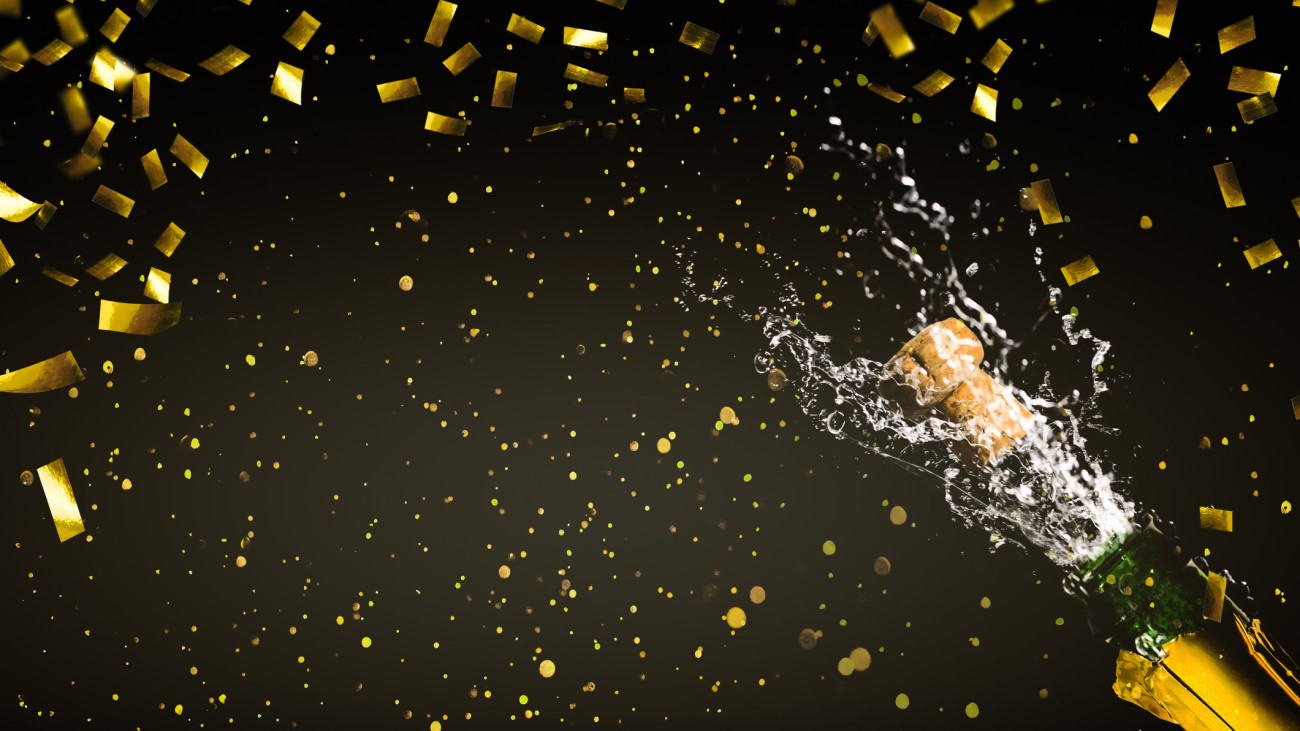 fizzing champagne in rainig gold confetti