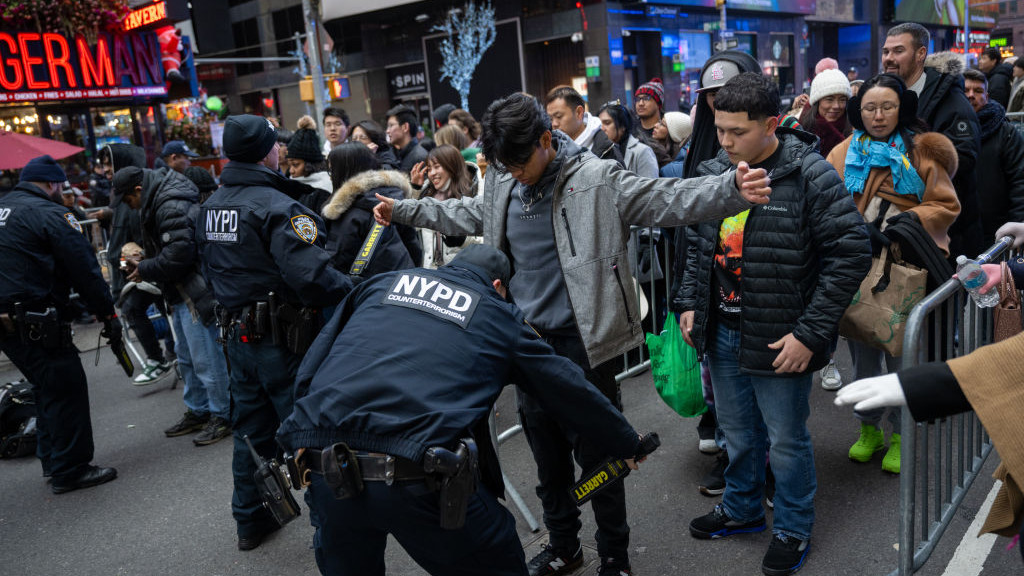 NEW YORK, NEW YORK - DECEMBER 31: People go through an NYPD security checkpoint ahead of the New Years Eve celebrations in Times Square on December 31, 2023 in New York City. People began filling Times Square around 10:30 a.m. and will wait more than 12 hours until the annual New Years Eve ball drop at midnight. Around 1 million people are estimated to fill Times Square, alongside a large police presence amid concerns about protests targeting the event. (Photo by Alexi Rosenfeld/Getty Images)