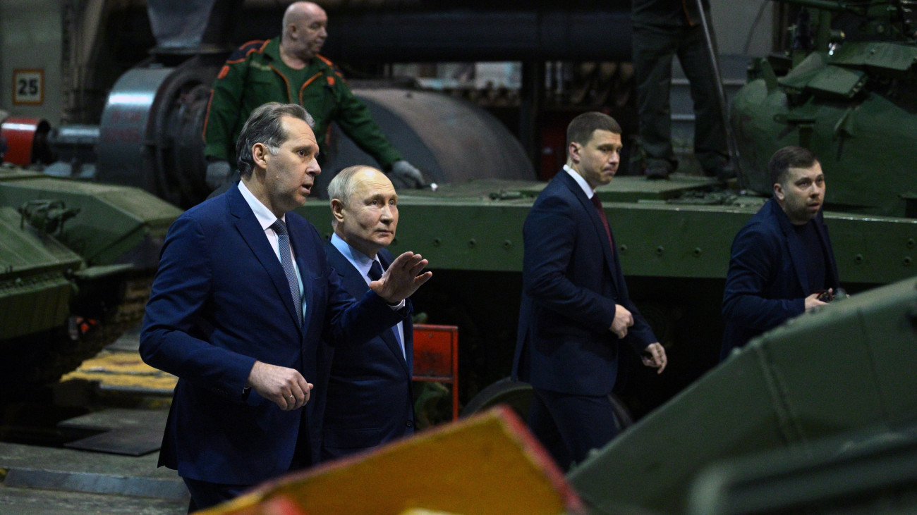 Vlagyimir Putyin orosz államfő (b2) és Alexandr Potapov, az UralVagonZavod orosz hadiipari vállalat vezérigazgatója (b) a vállalat Nyizsnyij Tagil-i gyárában tett látogatásán 2024. február 15-én, napokkal az Ukrajna elleni orosz háború kitörésének második évfordulója előtt.