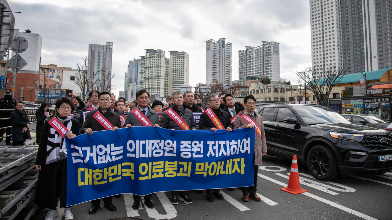 Demonstrators march during a protest against a government plan to increase the number of seats at medical schools in Seoul, South Korea, on Sunday, Feb. 25, 2024. A widespread walkout by South Korean trainee doctors is heading toward its second week with no sign that the government, which says the country urgently needs to boost the number of physicians, will back down from its plan.Â  Photographer: Jean Chung/Bloomberg via Getty Images