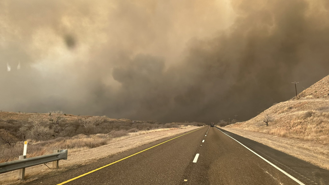 TEXAS, UNITED STATES - FEBRUARY 28: (----EDITORIAL USE ONLY - MANDATORY CREDIT - TEXAS A&M FOREST SERVICE / HANDOUT - NO MARKETING NO ADVERTISING CAMPAIGNS - DISTRIBUTED AS A SERVICE TO CLIENTS----) Smoke rises on the roadway in Hutchinson County after the Juliet Pass fire broke out in Armstrong County, Texas, United States on February 28, 2024. (Photo by Texas A&M Forest Service/Anadolu via Getty Images)