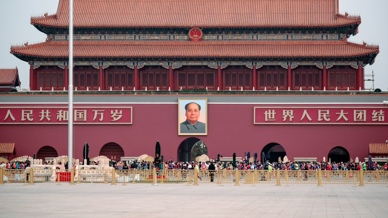 A pekingi maraton résztvevői a Tiltott Város Mao Ce-tung néhai kínai kommunista vezető óriásportréjával díszített északi kapuja előtt haladnak el a Tienanmen téren 2022. november 6-án. A pekingi maratont a koronavírus-járvány miatt két  évig nem rendezték meg.
