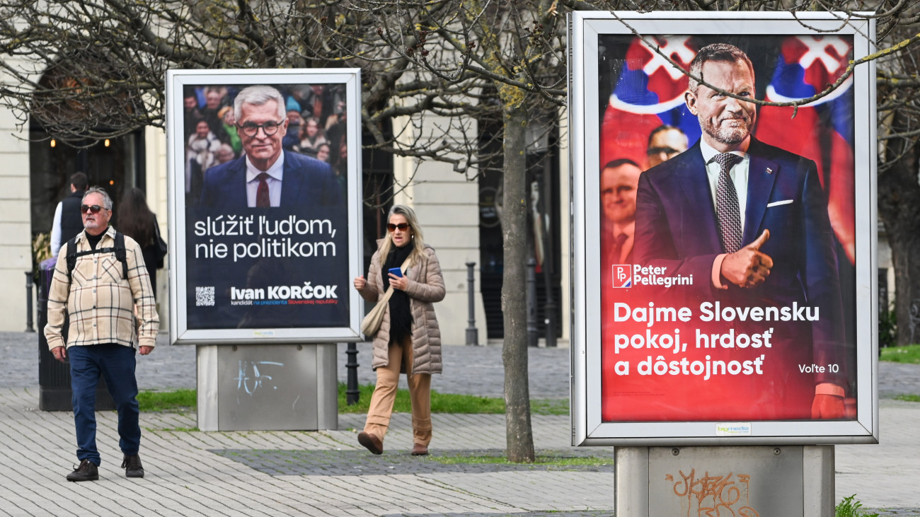 BRATISLAVA, SLOVAKIA - 2024/03/15: A couple walk by election posters of two presidential candidates: current speaker of the National Council Peter Pellegrini (R) and former Slovak foreign minister Ivan Korcok (L) on the street in Bratislava. Slovakia is set to conduct its first round of presidential elections on March 23, 2024, followed by the second round on April 6, 2024. The leading contenders, according to current presidential polls, are Peter Pellegrini, the current speaker of the Slovak National Council, and Ivan Korcok, a former Slovak foreign minister followed by Stefan Harabin and Igor Matovic. (Photo by Tomas Tkacik/SOPA Images/LightRocket via Getty Images)
