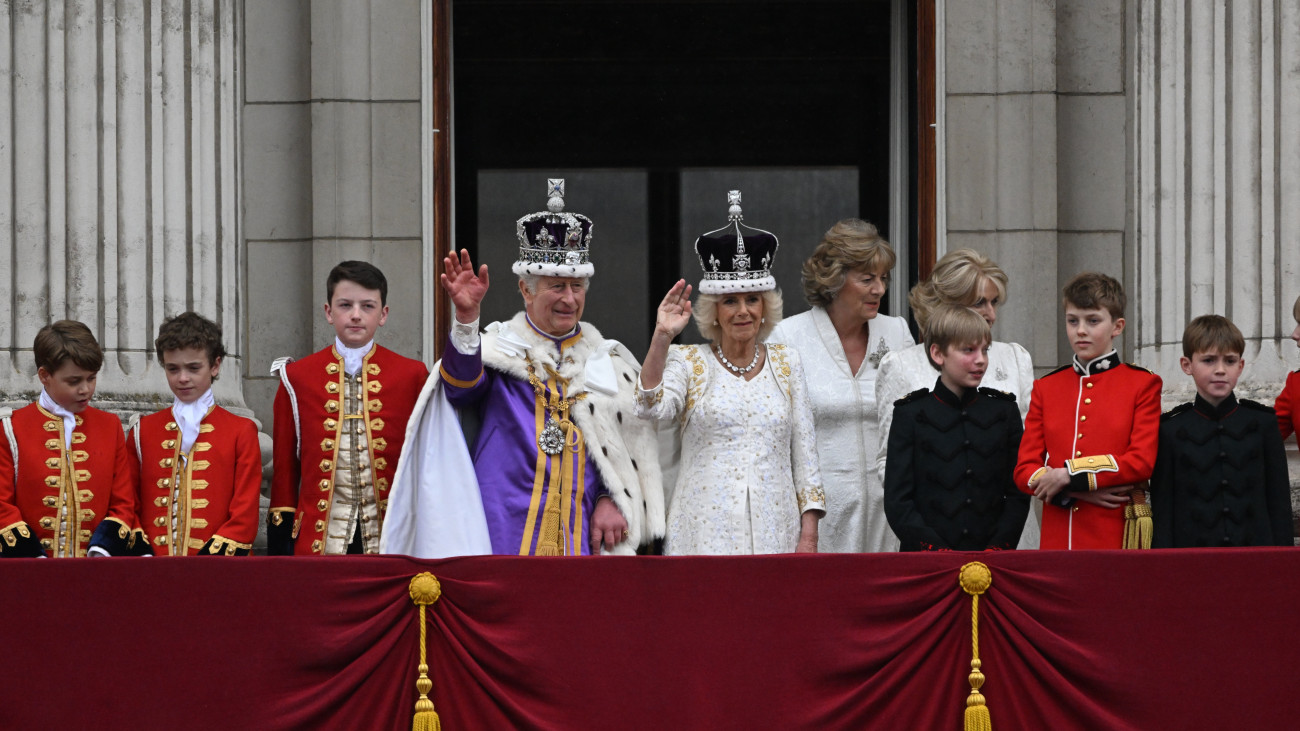 London, 2023. május 6.III. Károly brit király és a felesége, Kamilla királyné a londoni Buckingham-palota erkélyéről integet az uralkodó koronázási ünnepsége után, 2023. május 6-án. Balról a király unokája, az egyik apród szerepét betöltő György herceg, a trónörökös elsőszülött fia.