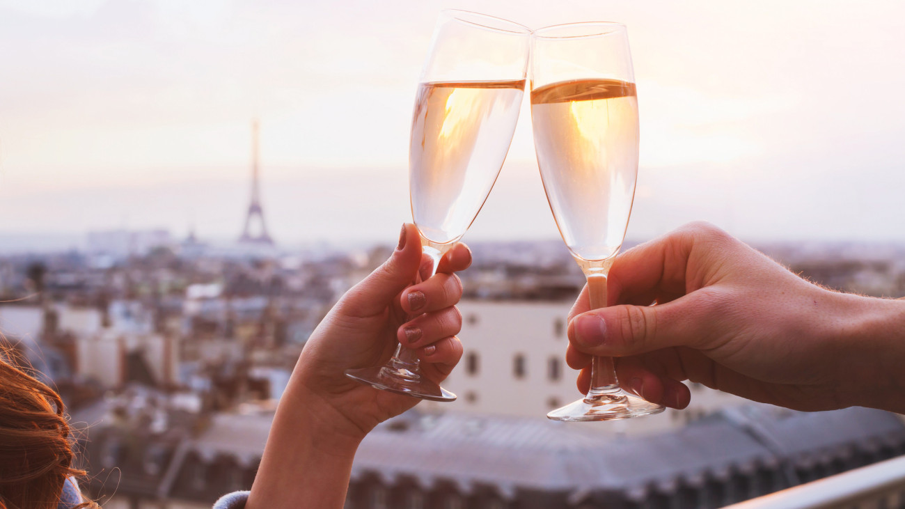 two glasses of champagne or wine, couple in Paris, romantic celebration of engagement or anniversary