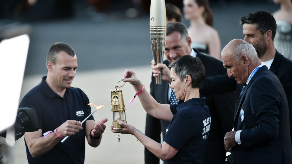 ATHENS, GREECE - APRIL 26: ATHENS, GREECE - APRIL 26: The Olympic flame is moved over to a lantern during the Olympic flame handover ceremony for the Paris 2024 Summer Olympics at Panathenaic Stadium on April 26, 2024 in Athens, Greece. (Photo by Milos Bicanski/Getty Images)
