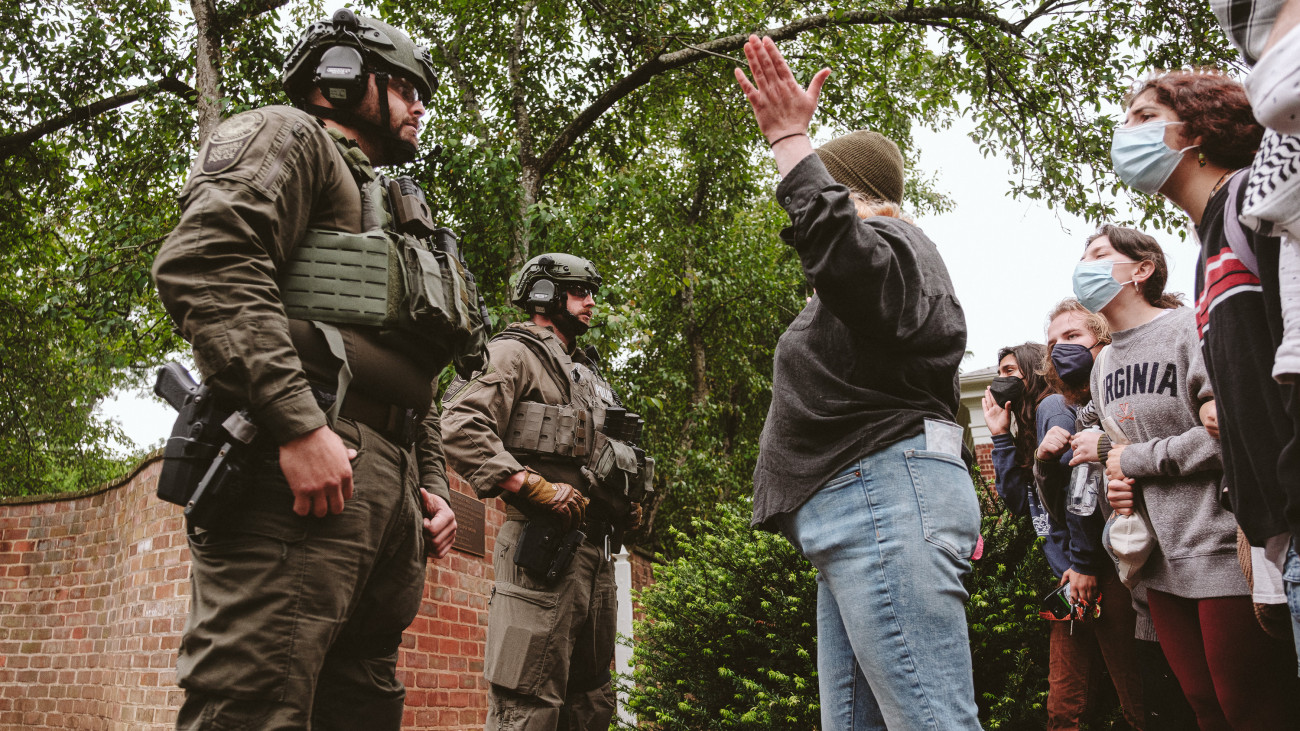 CHARLOTTESVILLE, VIRGINIA - MAY 04: A protester at the University of Virginia confronts the police as they try to disperse protesters from the encampment on university grounds. on May 4, 2024 in Charlottesville, Virginia. Pro-Palestinian encampments have sprung up at college campuses around the country with some demonstrators calling for schools to divest from Israeli interests amid the ongoing war in Gaza. (Photo by Eze Amos/Getty Images)