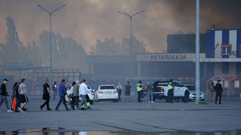 KHARKIV, UKRAINE - MAY 25: Local residents and police members stand on the parking lot near hypermarket âEpicentrâ after Russian air attack on May 25, 2024 in Kharkiv, Ukraine. According to the city authorities, after the strike, a fire broke out on an area of 15,000 square meters, and there are civilian casualties. Epicentr K is a home improvement hypermarket chain in Ukraine. (Photo by Denys Klymenko/Gwara Media/Global Images Ukraine via Getty Images)