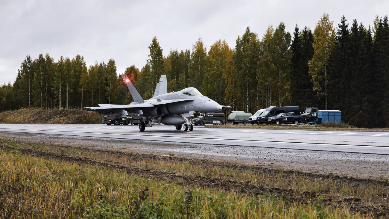 A Boeing F18 Hornet twin-engined multi-role fighter jet using highway four as a runway during the Finnish Air Force Academys Baana 22 exercise in Joutsa, Finland, Wednesday, Sept. 28, 2022. Officials guarding Finlands 1,300-kilometer (800-mile) border with Russia are calling for a fence to help prevent potential uncontrolled mass-scale entry from the east. Photographer: Roni Rekomaa/Bloomberg via Getty Images.
