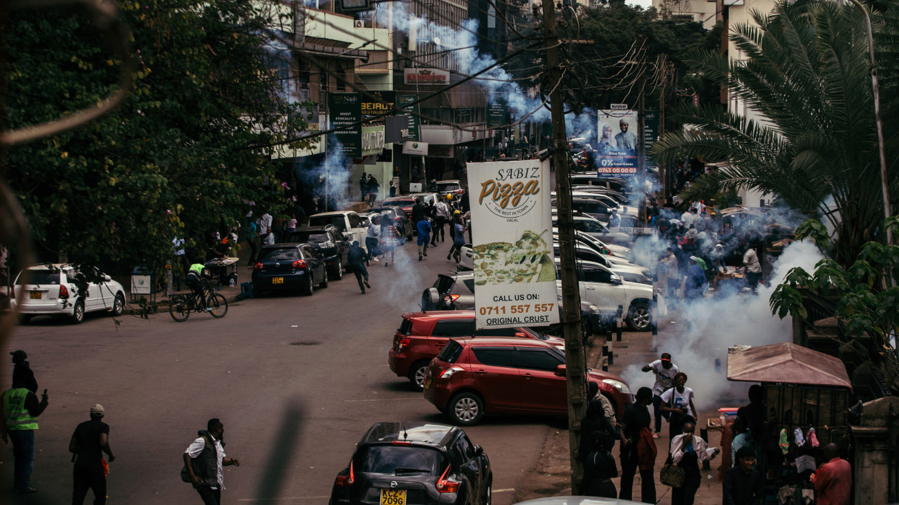 Police fire tear gas to clear protesters against the proposed government tax bill in the Central Business District of Nairobi, Kenya, on Tuesday, June 25, 2024. Anti-government demonstrators have called for a shutdown of the economy over revenue-raising measures they say are pushing more of the nations 54 million people into poverty. Photographer: Kang-Chun Cheng/Bloomberg via Getty Images