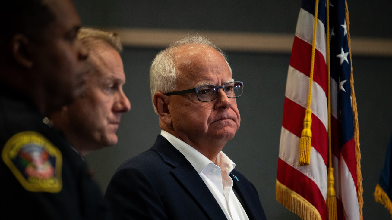 BLOOMINGTON, MINNESOTA - AUGUST 1: Minnesota Governor Tim Walz (R) listens during a press conference regarding new gun legislation at the Bloomington City Hall on August 1, 2024 in Bloomington, Minnesota. Walz is thought to be on a short list of potential Vice Presidential running mates for Democratic Presidential candidate and current Vice President Kamala Harris. (Photo by Stephen Maturen/Getty Images)