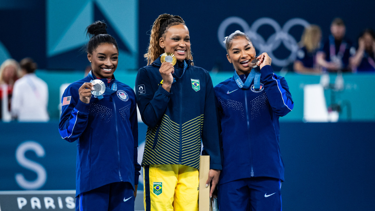 PARIS, FRANCE - AUGUST 5: Silver medalist Simone Biles of Team United States, Gold medalist Rebeca Andrade of Team Brazil and Bronze medalist Jordan Chiles of Team United States celebrate after the Artistic Gymnastics Womens Floor Exercise Final on day ten of the Olympic Games Paris 2024 at the Bercy Arena on August 5, 2024 in Paris, France. (Photo by Tom Weller/VOIGT/GettyImages)