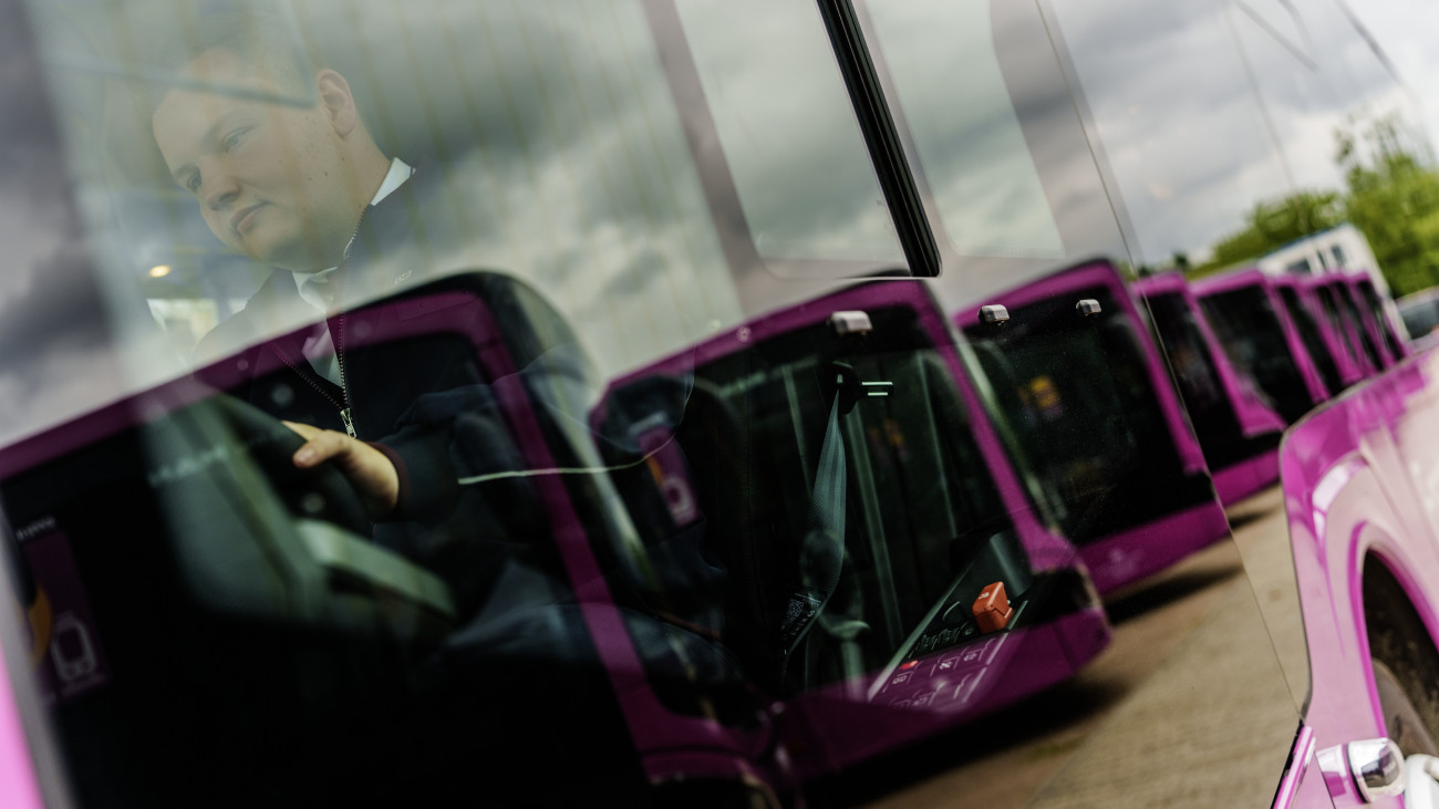 29 May 2024, Hesse, Darmstadt: A bus driver sits at his workplace. Deutsche Bahn will begin the general renovation of the Riedbahn from July 15. During the five months of construction work between Frankfurt and Mannheim, regional and suburban trains will be replaced by a substitute service with 150 new DB buses. Photo: Andreas Arnold/dpa (Photo by Andreas Arnold/picture alliance via Getty Images)