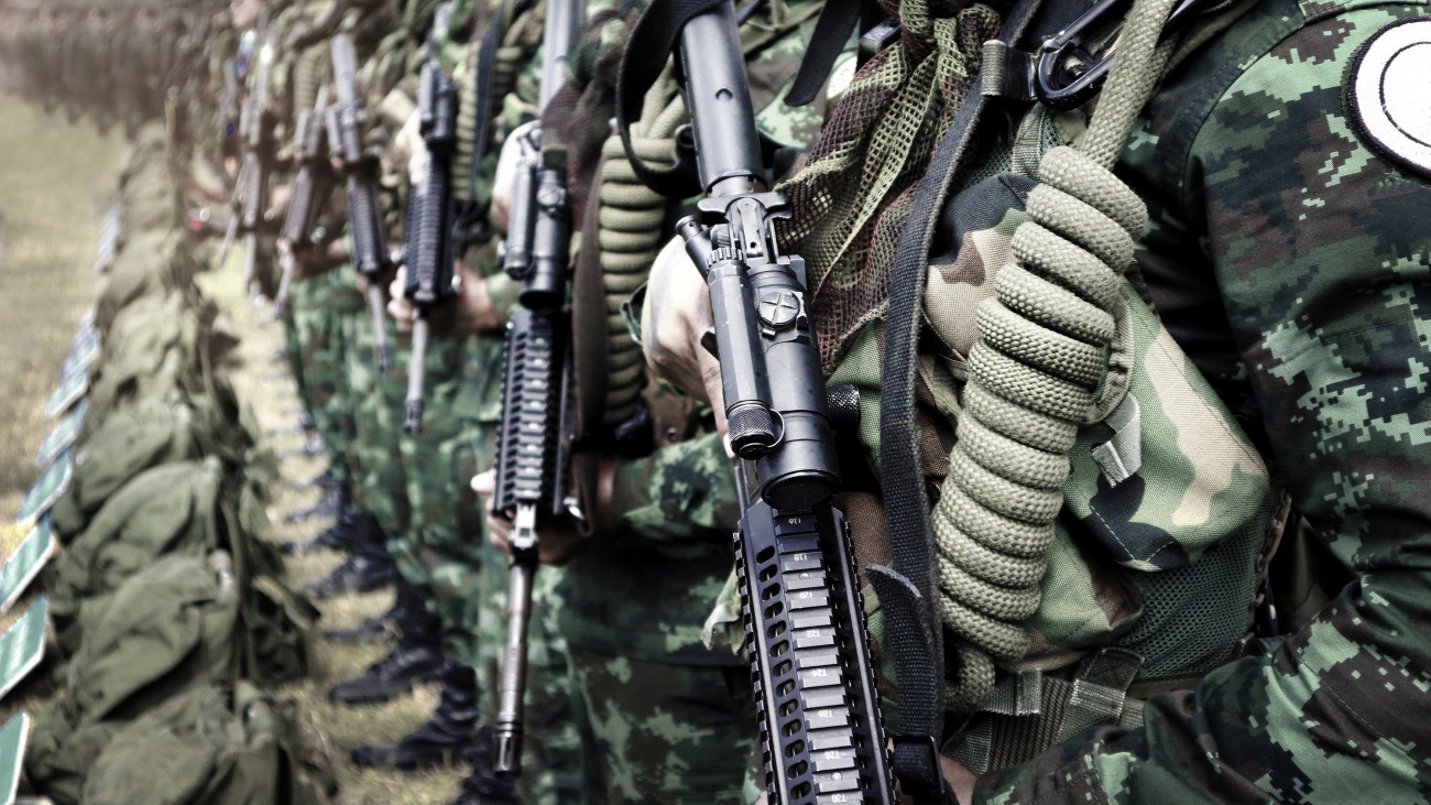 Thai soldiers stand in row.commando soldiers in camouflage uniforms gun in hand,close up of army and preparation for battle.