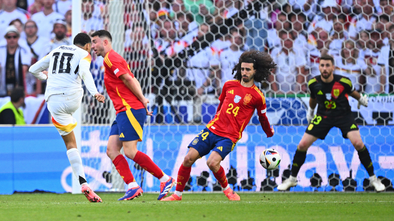 05 July 2024, Baden-WĂźrttemberg, Stuttgart: Soccer, UEFA Euro 2024, European Championship, Spain - Germany, final round, quarter-final, Stuttgart Arena, Germanys Jamal Musiala (l-r) in action against Spains Aymeric Laporte, Marc Cucurella and goalkeeper Unai Simon. Photo: Tom Weller/dpa (Photo by Tom Weller/picture alliance via Getty Images)