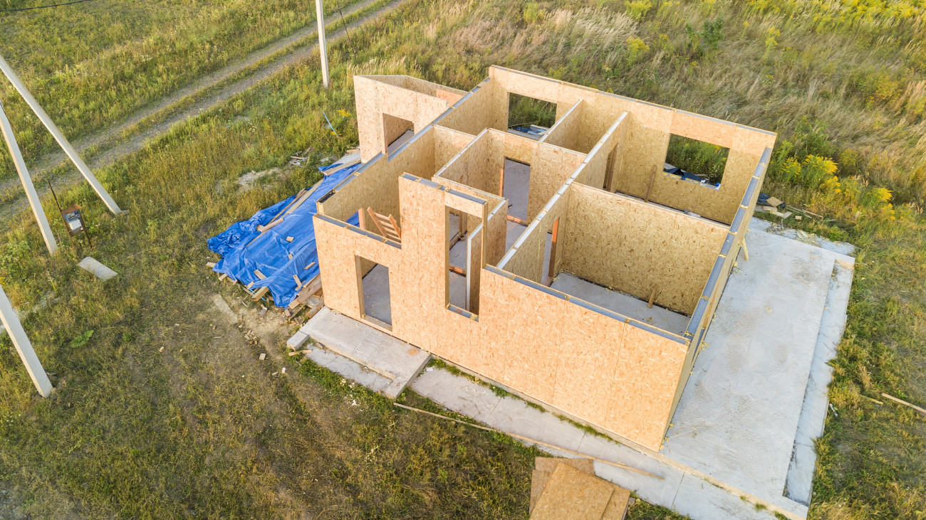 Construction of new and modern modular house. Walls made from composite wooden sip panels with styrofoam insulation inside. Building new frame of energy efficient home concept.