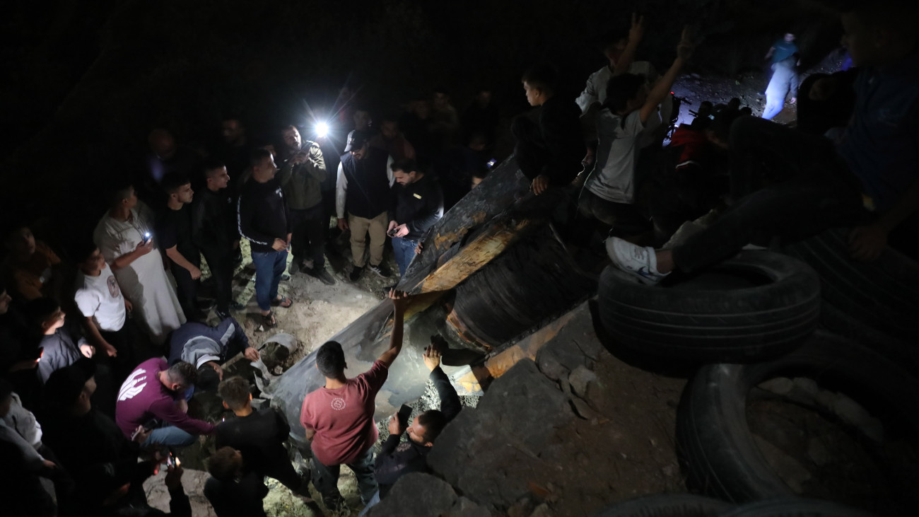 HEBRON, WEST BANK - OCTOBER 1: Palestinians inspect debris of a missile fired from Iran to Israel, after it falls on an area in Luza neighborhood, Hebron Governorate in West Bank on October 1, 2024. (Photo by Wisam Hashlamoun/Anadolu via Getty Images)