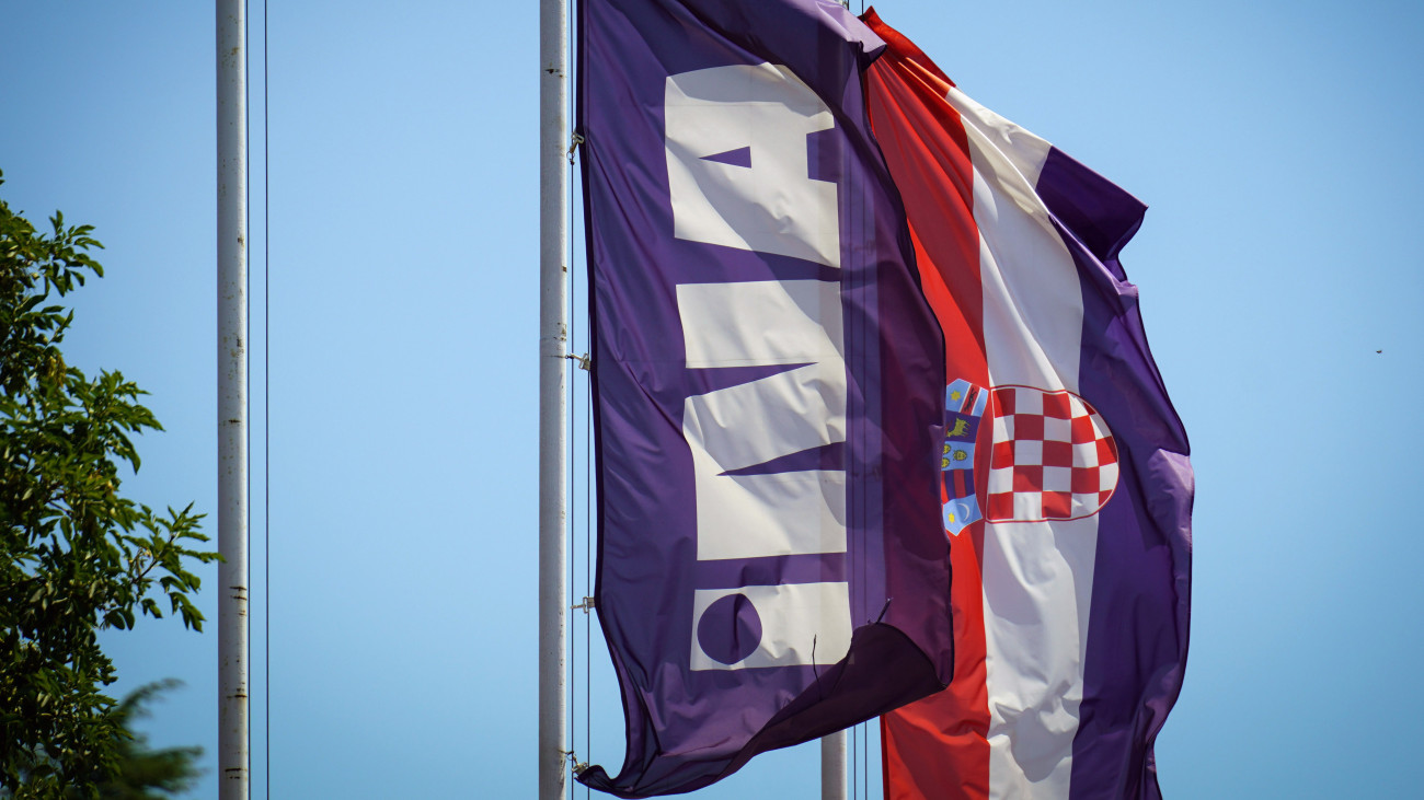 An INA Industrija Nafte d.d. flag and a Croatian national flag at the entrance to the companys oil refinery in Urinj, Croatia, on Monday, July 18, 2022. The European Union last week gave its final approval for Croatia to join the euro zone early next year as the regionÂ looks to strike a delicate balance between bringing down inflation and sustaining output as the region risks a total cut off of Russian gas. Photographer: Oliver Bunic/Bloomberg via Getty Images